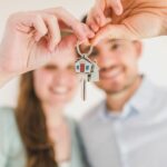 Clause d'accroissement : couple montrant la clé de sa maison achetée à deux en Belgique / Beding van aanwas bij een gezamenlijke woningaankoop